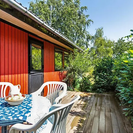 The Red Summer House With The Lush Garden At