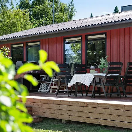 The Red Summer House With The Lush Garden At *