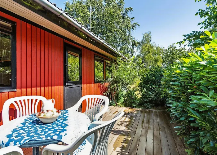 The Red Summer House With The Lush Garden At