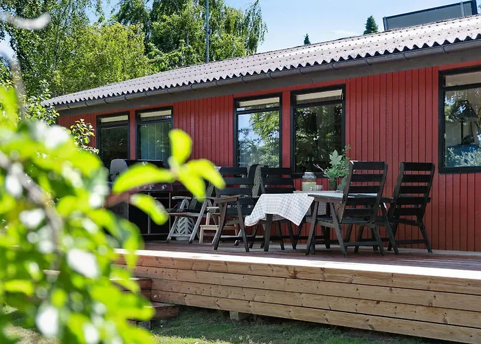 The Red Summer House With The Lush Garden At *